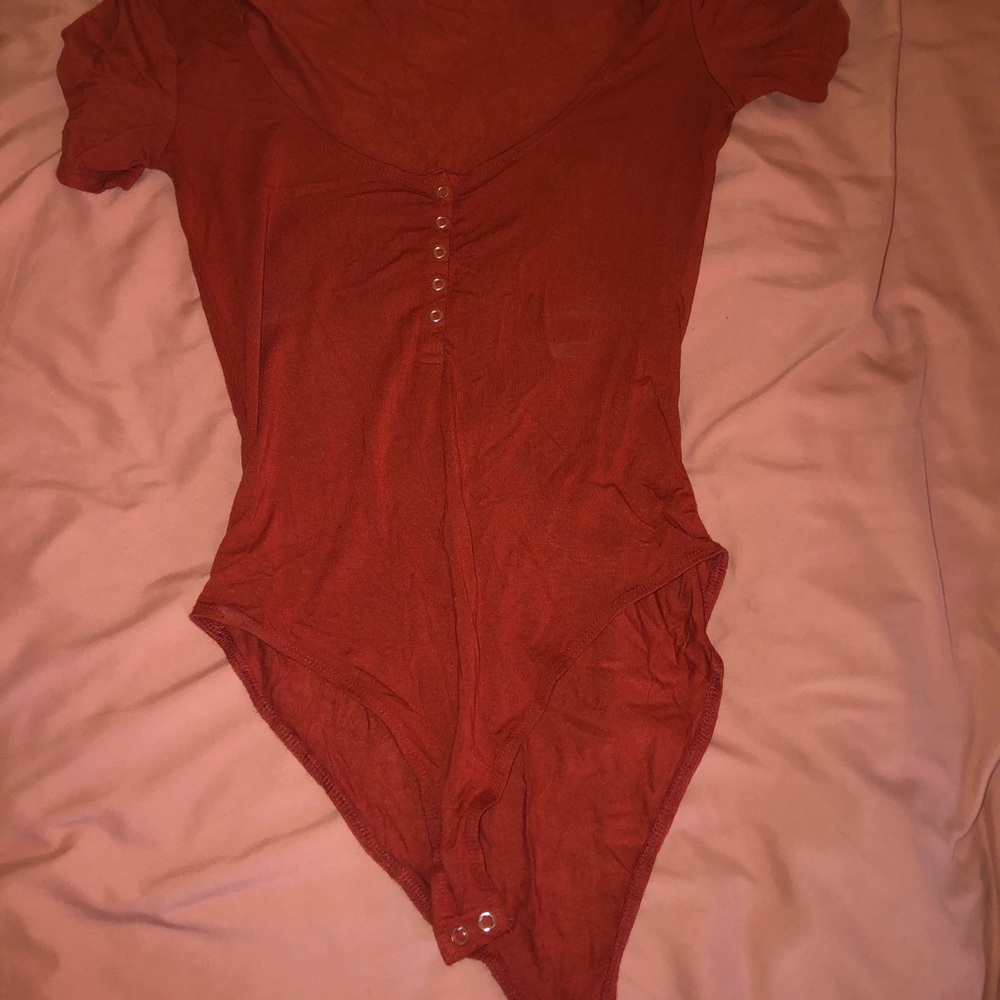 burnt orange wide neck body suit with buttons